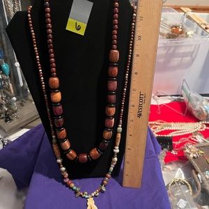 2 necklaces for the price . Wooden beads and glass beads